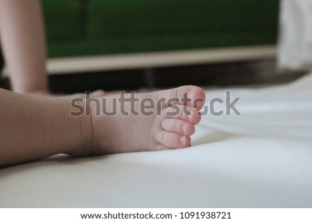 Baby feet on white background. Happy Family concept. Beautiful conceptual image of Maternity.