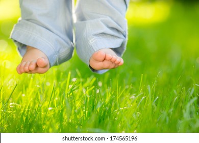 Baby Feet Over Green Spring Grass