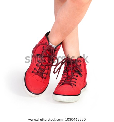 baby feet in red shoes on a white background