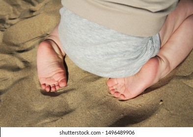 Baby Feet In The Sand At The Beach During Vacations. Traveling With Kids. Family Holiday Concept.