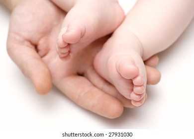 Baby Feets Lying On A Father`s Hand