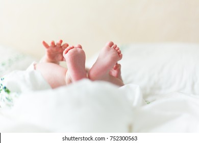 Baby Feets In White Bed