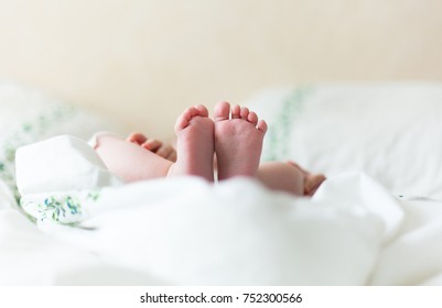 Baby Feets In White Bed