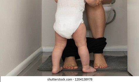 Baby Follows Mother To The Toilet