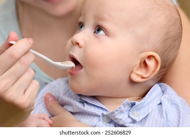 Baby Food, Baby Eating. Mother Feeding Her Baby Boy By Spoon.