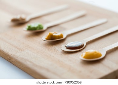 Baby Food, Healthy Eating And Nutrition Concept - Vegetable Or Fruit Puree In Wooden Spoons