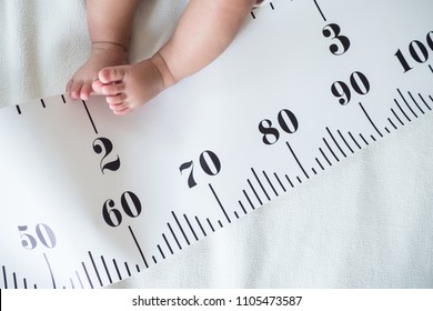 Baby Foot And Measuring Tape: Concept Of Baby Growth, Height, Development