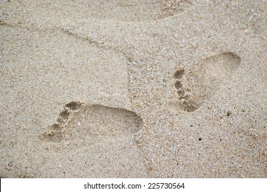 Baby Footprints In The Sand Of A Beach