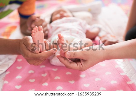 Baby foots on mother and father hand.Parents couple holding new born feets child in hands.Newborn baby and family concept.