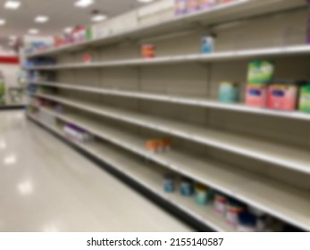 A baby formula display sits empty at supermarket as a result of nationwide baby formula shortage. Abstract blur.  - Shutterstock ID 2155140587