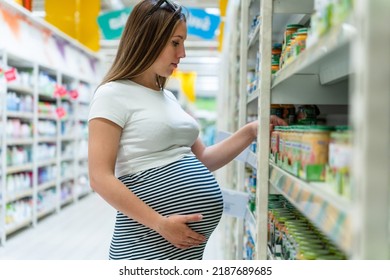 Baby Formula Pregnant Woman Shopping. Young Pregnant Woman Buying Infant Baby Formula Milk On Supermarket Background. Everyday Shopping Baby Formula Concept