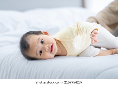 Baby Girl With Asian Mom Smiling Baby Happily Playing Together In Bed In The Bedroom At Home