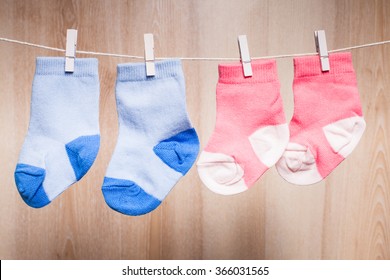 Baby Girl And Boy Socks Attached To The Rope