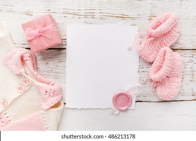 Baby Girl Clothes With Blank Card On Wooden Background. Flat Lay. Owerhad View