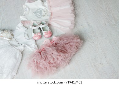 Baby Girl Clothes Set On Wooden Background Copy Space