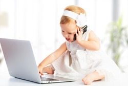 Baby Girl With Computer Laptop And Mobile Phone