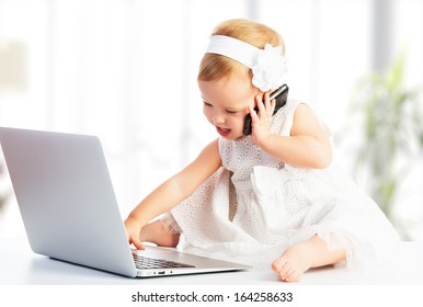 baby girl with computer laptop and mobile phone