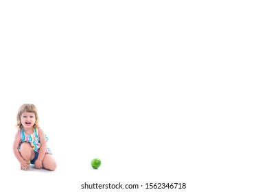 Baby Girl Cries, Does Not Want To Eat Fruit. Threw Out An Apple. The Child Is In A Bad Mood, Screaming And Indignant. No Appetite. Isolated On White Background