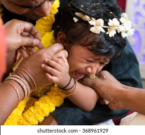 Baby Girl Crying During The Karna Vedha Events. Traditional Indian Hindus Ear Piercing Ceremony. India Special Rituals.