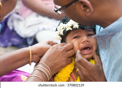 Baby Girl Crying In The Karna Vedha Events. Traditional Indian Hindus Ear Piercing Ceremony. India Special Rituals.