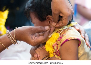 Baby Girl Crying In The Karnavedha Events. Traditional Indian Hindus Ear Piercing Ceremony. India Special Rituals For Children.