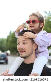 baby girl with daddy. cute baby girl with dad. father and daughter. baby in purple coat with sunglasses plays with daddy. daddy's girl. adorable baby with father. family together. dad holding daughte. - Shutterstock ID 2169516571