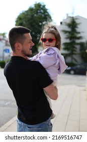 baby girl with daddy. cute baby girl with dad. father and daughter. baby in purple coat with sunglasses plays with daddy. daddy's girl. adorable baby with father. family together. dad holding daughte. - Shutterstock ID 2169516747