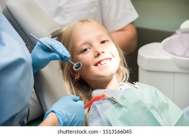 Baby Girl In The Dental Chair. Tooth Treatment Process