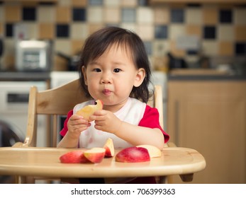 Baby Girl Eating  Apple At Home