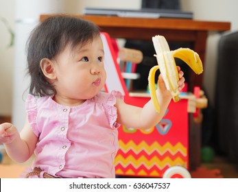 Baby Girl Eating Banana At Home