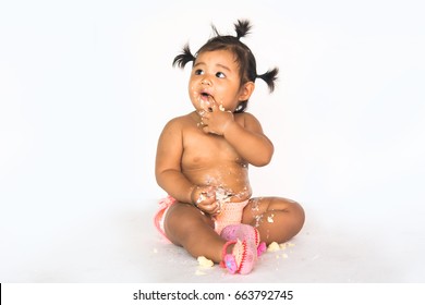 Baby girl eating cake