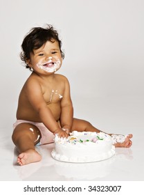Baby girl eating her birthday cake.