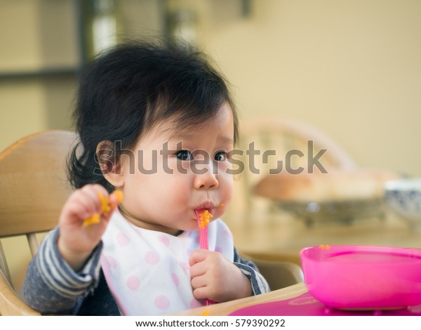 Baby Girl Eating Mashed Sweet Potatoes Stock Photo 579390292 Shutterstock