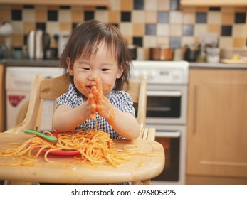 Baby Girl Eating Messy Spaghetti At Home