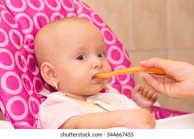 Baby Girl Eating With Spoon