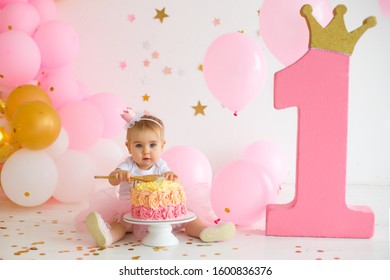 Baby girl  at first birthday with smash cake