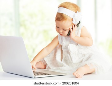 baby girl at a laptop computer, mobile phone