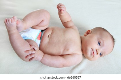 Baby Girl Laying On Back And Wearing A Diaper