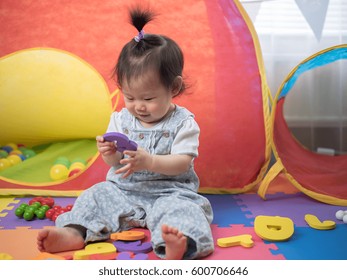 Baby Girl Learning Alphabet Blocks