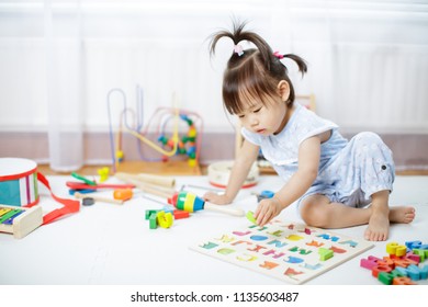 Baby Girl Learning Alphabet At Home