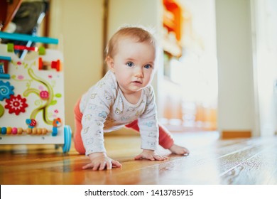 Baby girl learning to crawl. Happy healthy little child on the floor. Infant kid at home - Shutterstock ID 1413785915