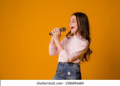 Baby Girl With Microphone Smiling Singing,Fat Girl Singing Song Into Microphone. Young Star, Looking For Talents.