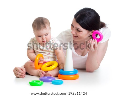 baby girl and mother playing together with toy