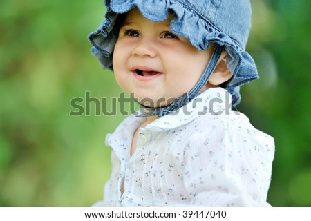 Similar – small girl wearing a hat singing happily