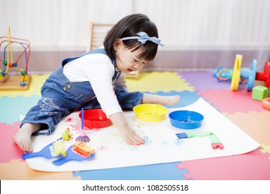 baby girl painting at home