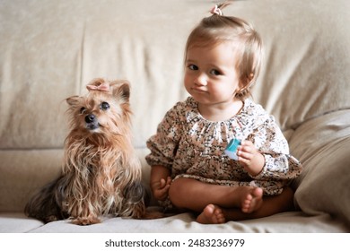 Baby Girl and Pet Dog Enjoying Time Together Indoors.Playful Baby With Funny Gesture And A Puppy Playing At Home. - Powered by Shutterstock