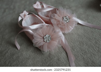 Baby girl pink christening shoes. Fragment photo of little baby girl preparing for baptism ceremony. Baptism dress on christening day. Baby  ceremonial clothes. - Powered by Shutterstock