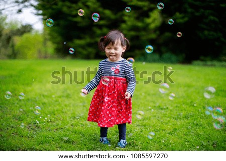 Similar – Image, Stock Photo baby girl outdoors in a park using mobile phone