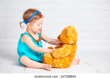 Baby Girl Playing Doctor And Treats Teddy Bear