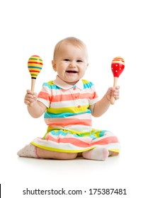 Baby girl playing with musical toys. Isolated on white background
